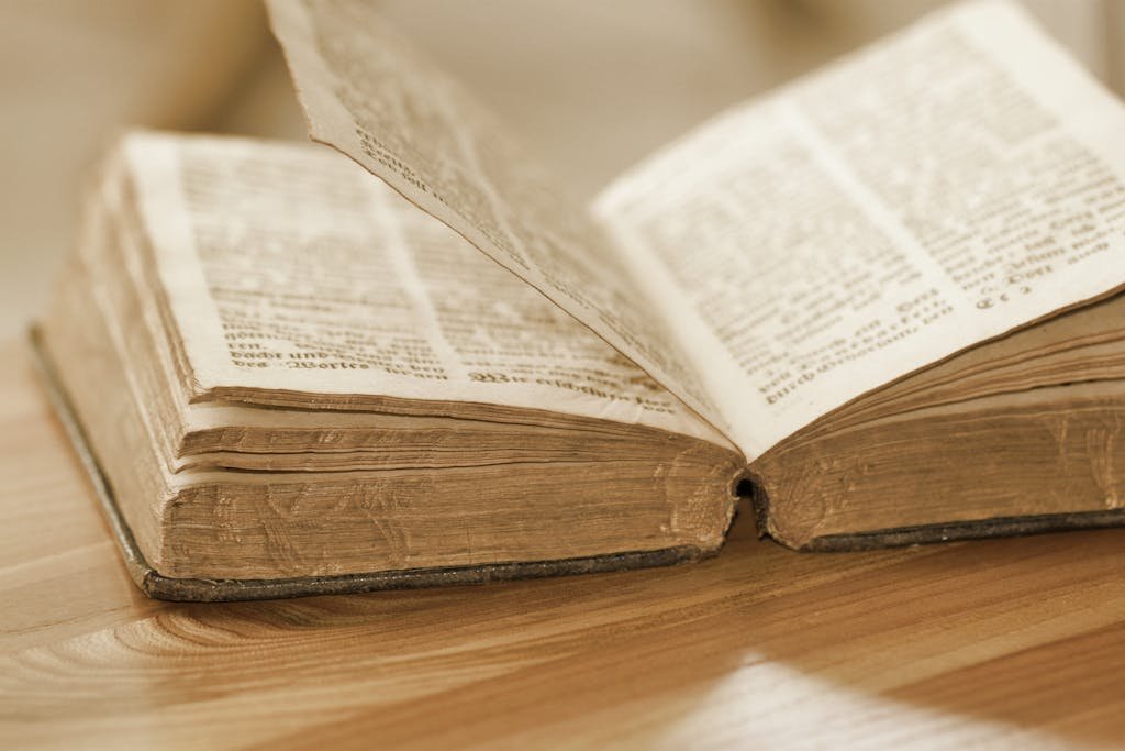 Vintage open book on a wooden table, highlighting old pages and text, perfect for knowledge and history themes.